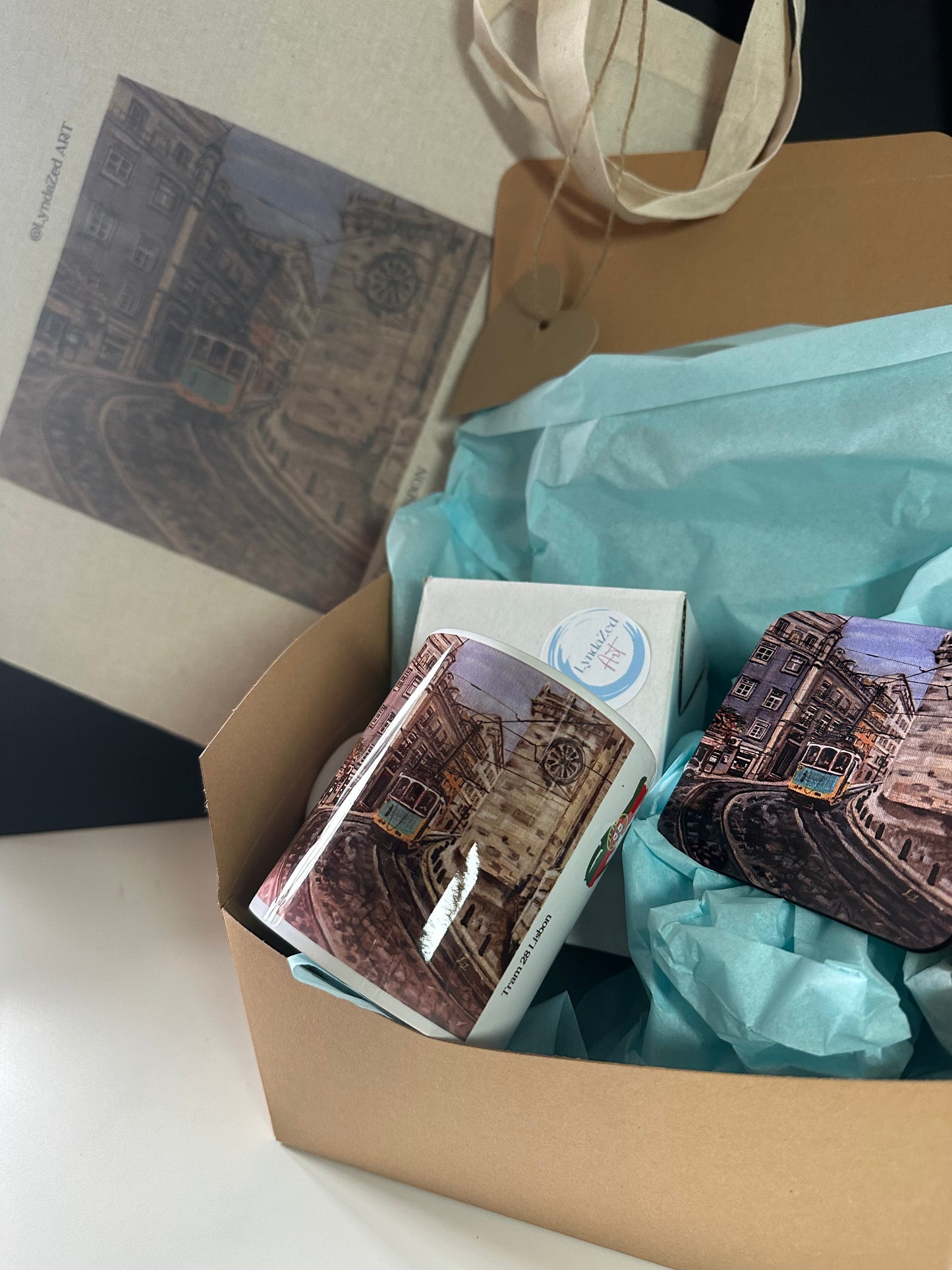 Tram 28 Lisbon giftbox open showing tote bag mug and coaster