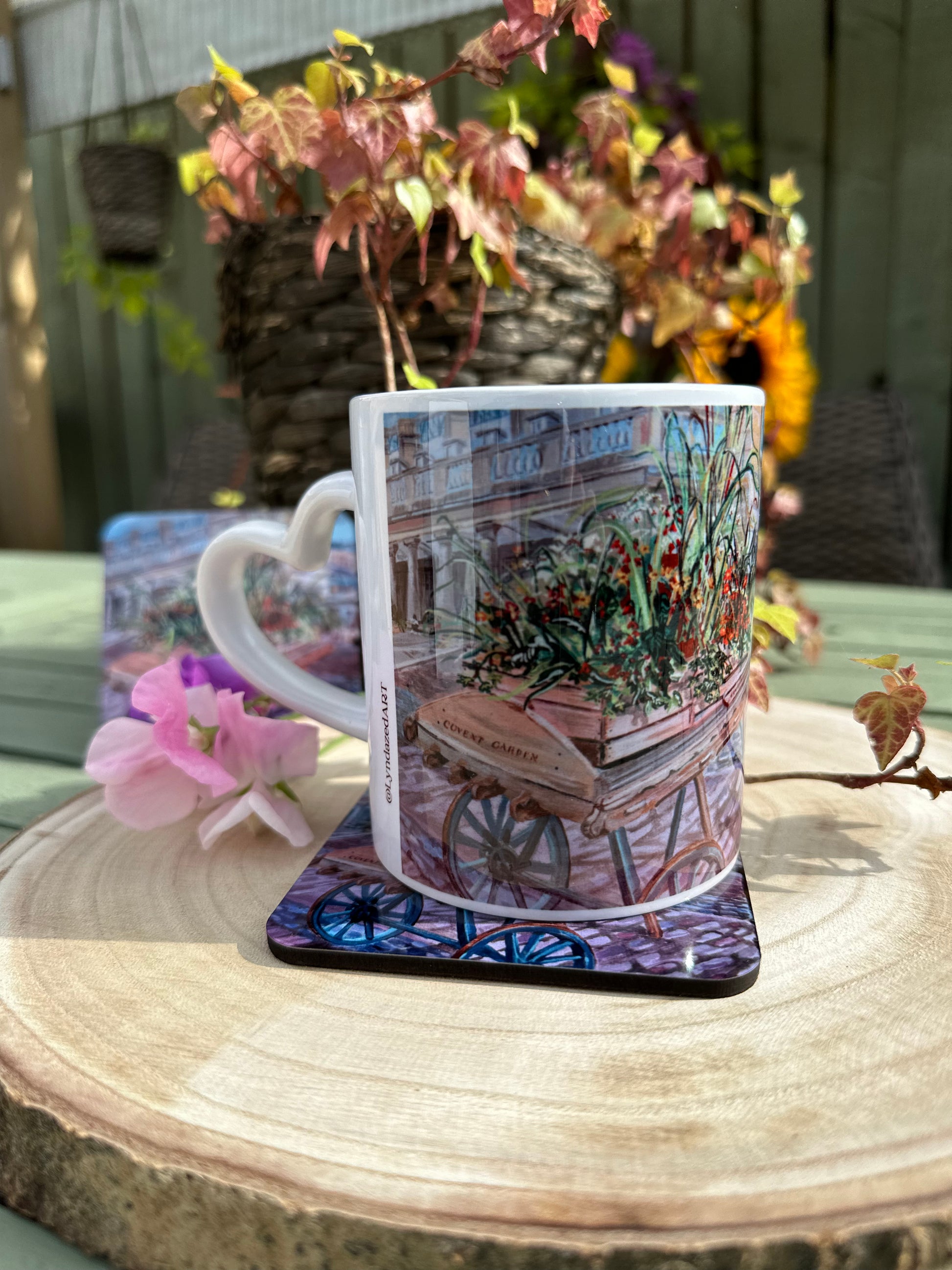 Covent Garden giftbox mug on coaster atop wooden slice