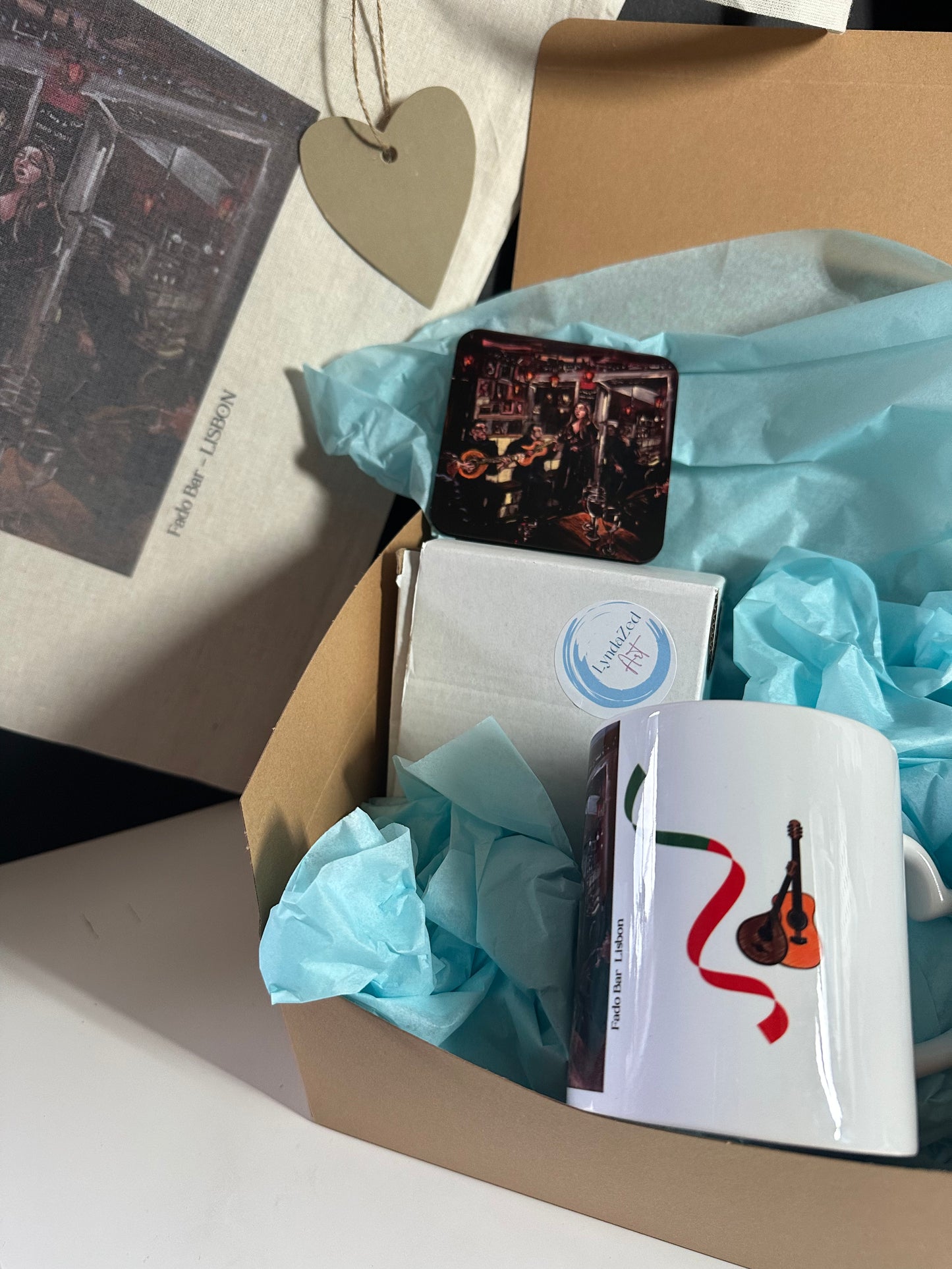 Fado Bar Lisbon  Giftbox showing tote in background, coaster and mug guitar graphics