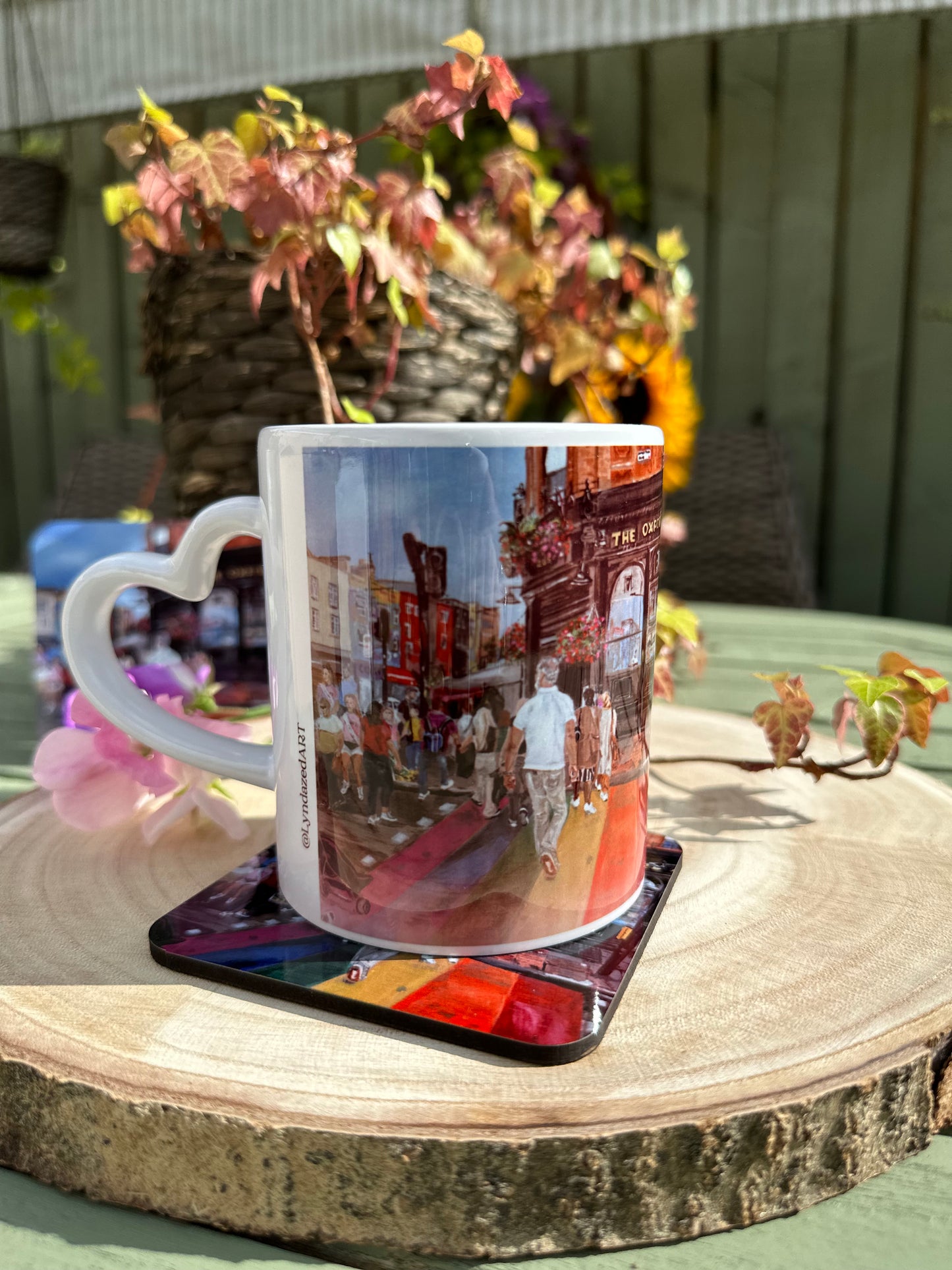 Rainbow Crossing giftbox showing hearthandled mug on coaster atop wooden slice