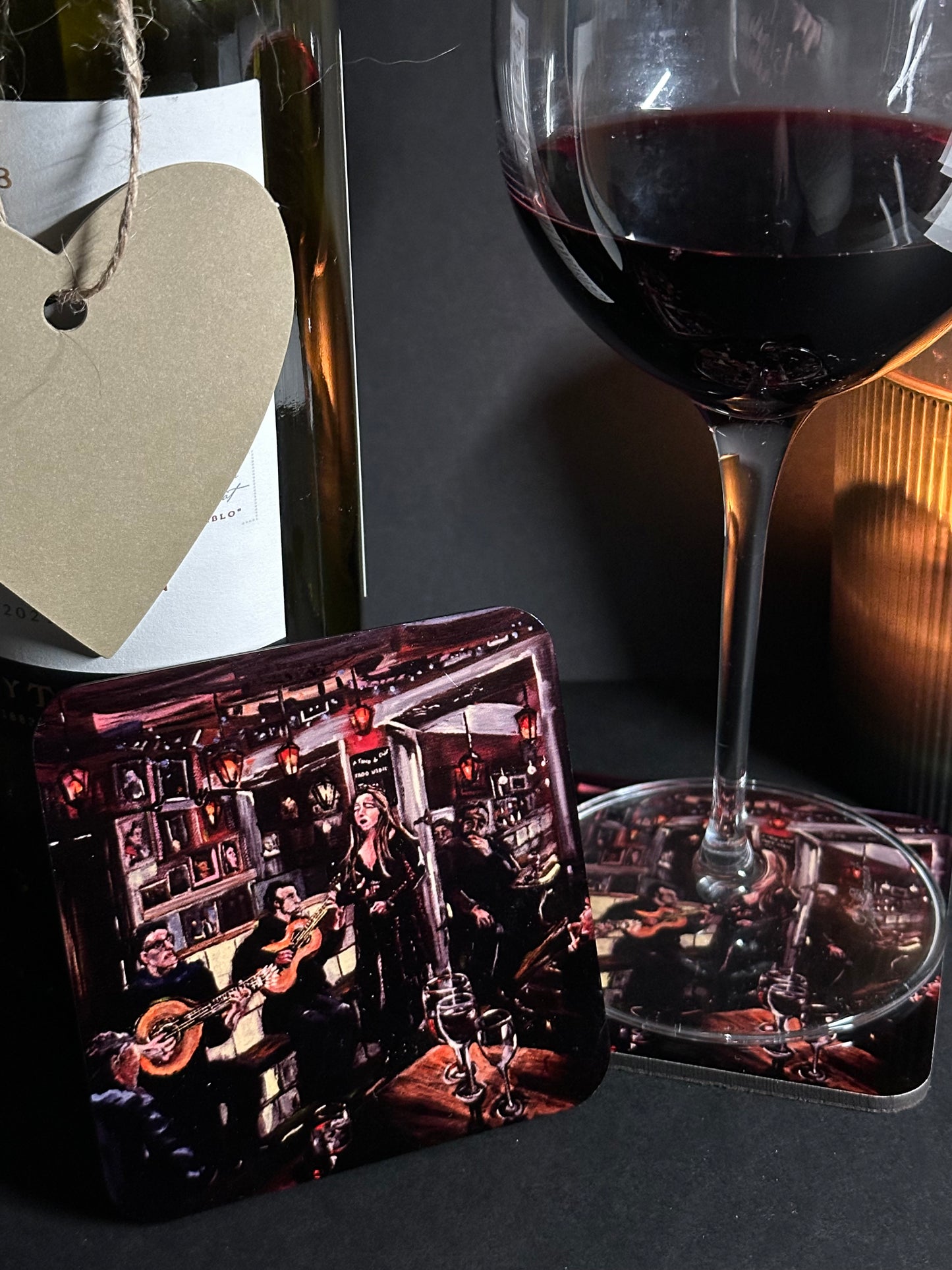 Fado Bar Lisbon coaster set in use candle light with wine glass rested on coaster and coaster detail upright to foreground